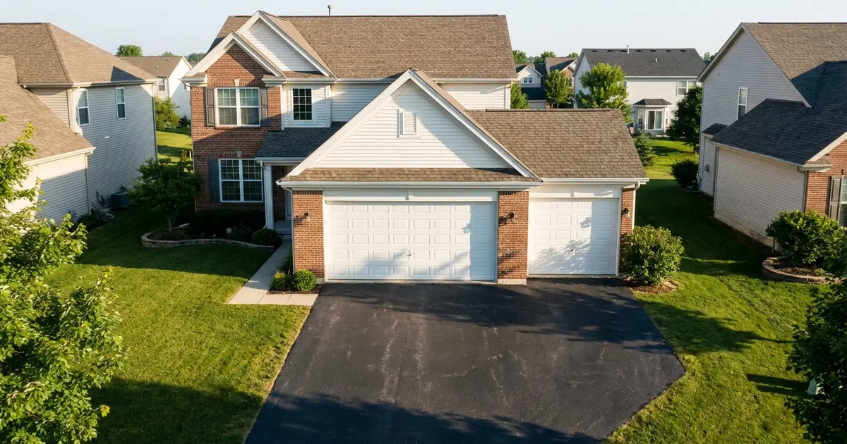 Suburban home exterior showing both single and double garage doors